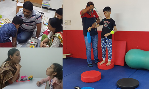 CRIA Foundation therapist working one-on-one with a young child using picture cards in a therapy room